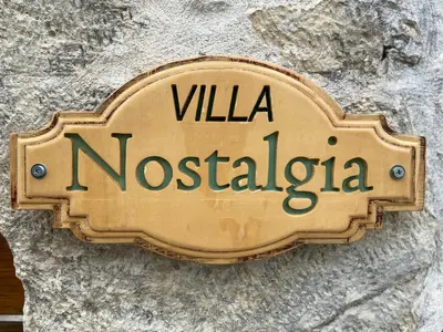 a sign on the side of a stone wall at Old stone villa in Apokoronas Villa Nostalgia Kreta in Fílippos