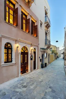 a building with doors and windows on a street at Neorion Living in Chania Town