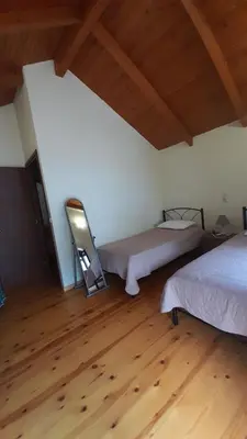 a room with two beds and a wooden floor at Traditional Stone House Rafael in Tzitzifés