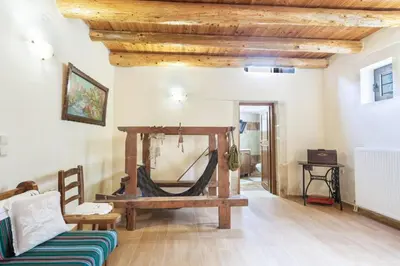 a living room with a bench and a wooden ceiling at Traditional Stone House Rafael in Tzitzifés