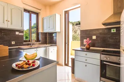 a kitchen with a plate of fruit on a counter at Olive Farm in Agia Marina Nea Kydonias
