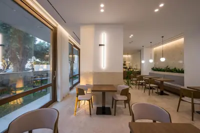 a restaurant with wooden tables and chairs and windows at SanSal Boutique Hotel in Chania Town