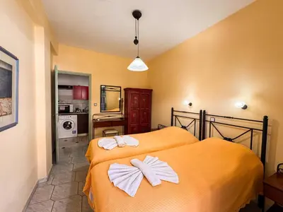 a bedroom with a bed with bows on it at Villa Eleni Seaside Apartments in Plataniás