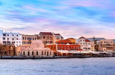 a group of buildings next to a body of water at Helios Residence in Chania Town