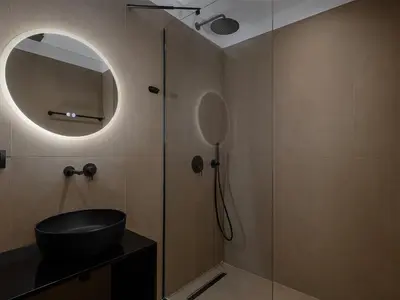 a bathroom with a sink and a mirror at Xenios Dias Luxury Apartments With Sea View in Kato Daratso
