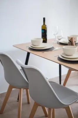 a table with two chairs and a table with cups and plates at Casa Ntore Luxury Apartments in Chania Town