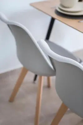 a pair of white chairs next to a table at Casa Ntore Luxury Apartments in Chania Town