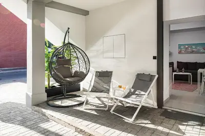 a patio with two chairs and a swing at Cozy Corner Luxury Apartments in Chania Town