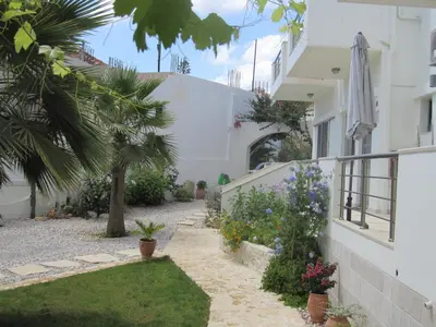 a courtyard of a house with flowers and plants at Lion-Suites in Kalyves