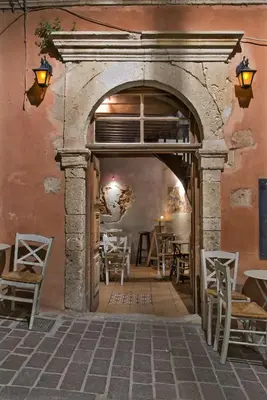 an archway in a building with tables and chairs at Fagotto Art Residences in Chania Town