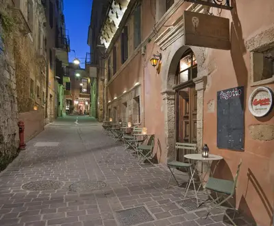 an alley with tables and chairs on a street at Fagotto Art Residences in Chania Town