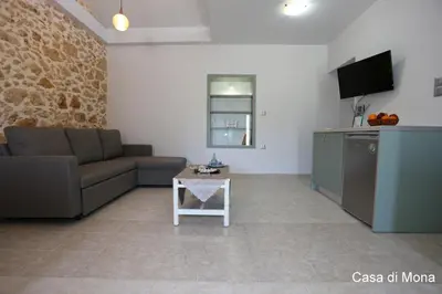 a living room with a couch and a table at Casa di Mona in Chania Town