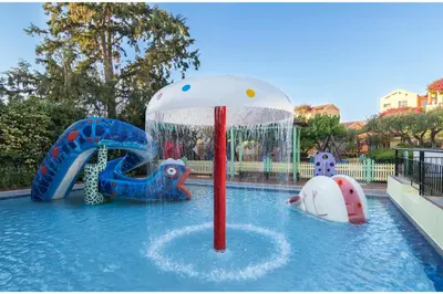 a pool with some inflatable animals in the water at Stefan Village Hotel in Agia Marina Nea Kydonias