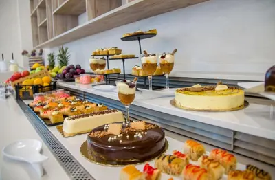 a buffet with many different types of cakes and desserts at Stefan Village Hotel in Agia Marina Nea Kydonias