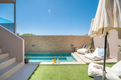 a swimming pool in the backyard of a house at Aegean Breeze Luxury Apartments next to the sea in Maleme