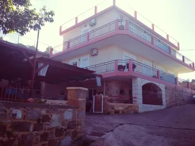 a building with a balcony on top of it at Riza Falasarna Apartments in Falasarna