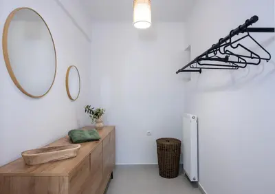 a bathroom with a wooden vanity and a mirror at Elenas Village house - Dream apt w Pool & Terrace in Alikianós