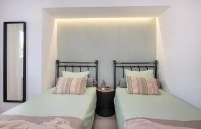 two beds sitting next to each other in a room at Elenas Home - Dream & Love apts w Private pool in Alikianós