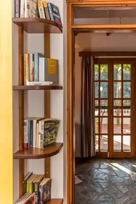 a book shelf with books on it next to a door at Spitia Anoi in Palaiochóra