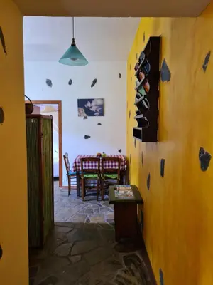 a room with a table and a bunch of wine bottles at Spitia Katoi in Palaiochóra