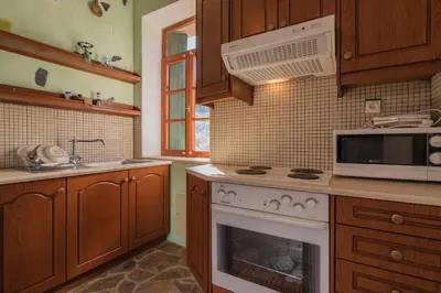 a kitchen with a stove and a microwave at Spitia Katoi in Palaiochóra