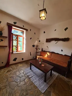 a living room with a couch and a table at Spitia Katoi in Palaiochóra