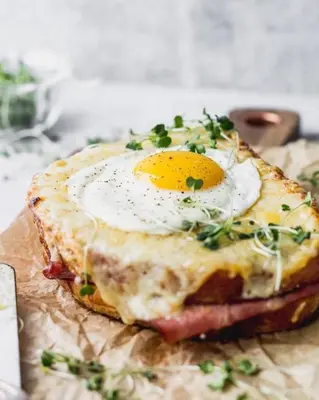 a breakfast sandwich with an egg on top of it at Casa Bene in Chania Town