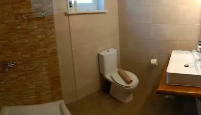 a bathroom with a toilet and a sink at Chania Nice Apartment in Chania Town