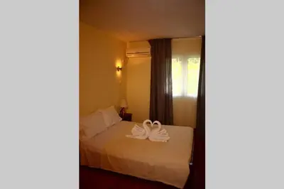 a hotel room with a bed with a towel on it at Kaktos 1 in Kissamos