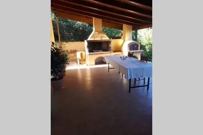 a living room with a table and a fireplace at Kaktos 1 in Kissamos
