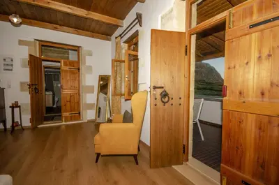 a living room with a chair and a window at Trouli Rokka House in Kissamos