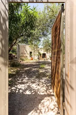 an open door to a yard with a building at Villa Aloni in Fílippos