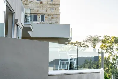 a white chair sitting on the balcony of a house at Abella Hotel in Agia Marina Nea Kydonias