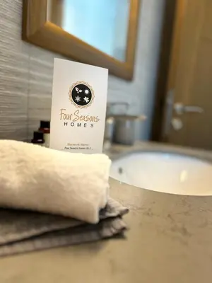 a book sitting on a bathroom counter next to a sink at Four Seasons Homes in Stalos