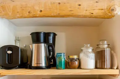 a coffee maker on a shelf with other items at Charming Studio in the Old Town in Chania Town