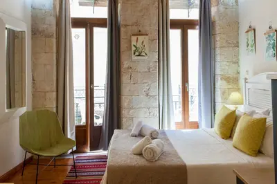 a bedroom with a bed with towels on it at Charming Studio in the Old Town in Chania Town