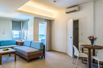 a living room with a couch and a table at Despina Apartments in Plataniás