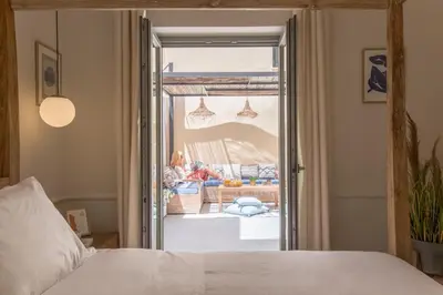 a bedroom with a bed and a living room at Casa Dei Miracoli in Chania Town