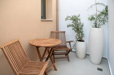a small table and two chairs and a vase at Casa Dei Miracoli in Chania Town
