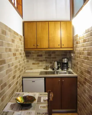 a small kitchen with a sink and a table at Casa Dasyra in Chania Town