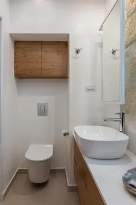 a white bathroom with a sink and a toilet at Chania Escapes City Loft 50 meters by the Sea in Chania Town