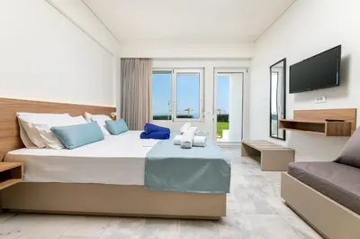 a bedroom with a large bed with a flat screen tv at Kostakis Beach in Gerani Chanion