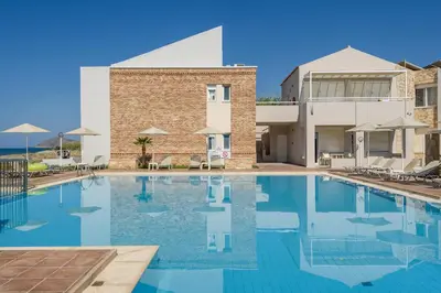 a swimming pool in front of a building at Kostakis Beach in Gerani Chanion