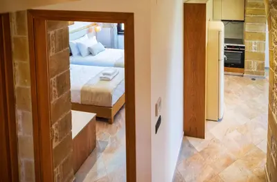 a view of a bedroom with a bed and a mirror at Athinais villa in Palaiochóra