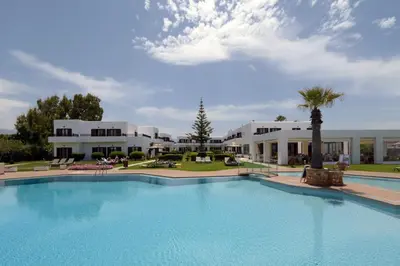 a large swimming pool in front of a building at Geraniotis Hotel and Resort in Plataniás