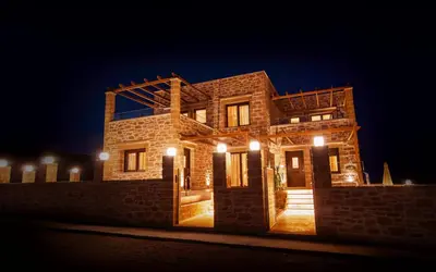 a stone house at night with lights on it at Anma Villa in Palaiochóra