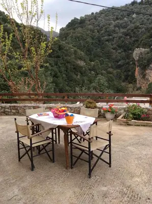 a table and chairs with a view of a mountain at Kleanthi's House in Chania Town