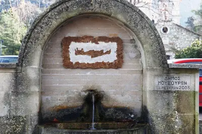 a water fountain in a stone wall with aestone at Kleanthi's House in Chania Town