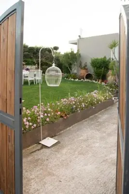 a door open to a yard with a bird cage at Villa sotiris in Kissamos
