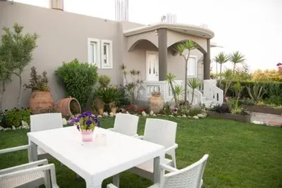 a white table and chairs in front of a house at Villa sotiris in Kissamos